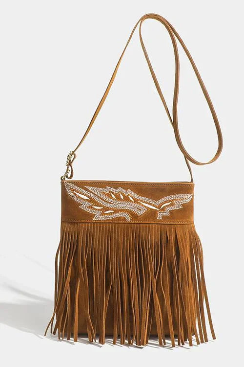 Front view of brown suede crossbody bag with fringe and rhinestone detail