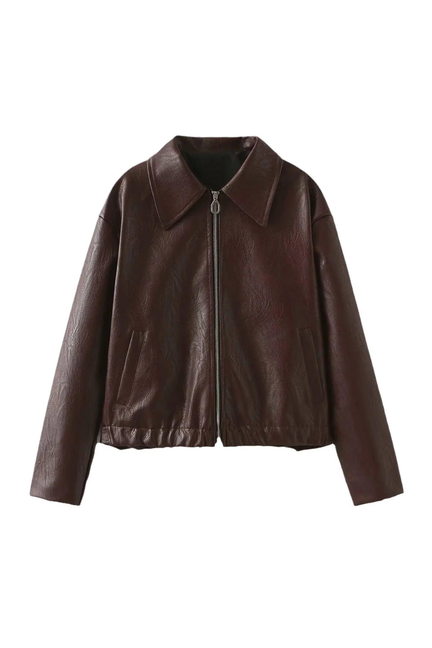 Woman in burgundy faux leather bomber jacket and black jeans.