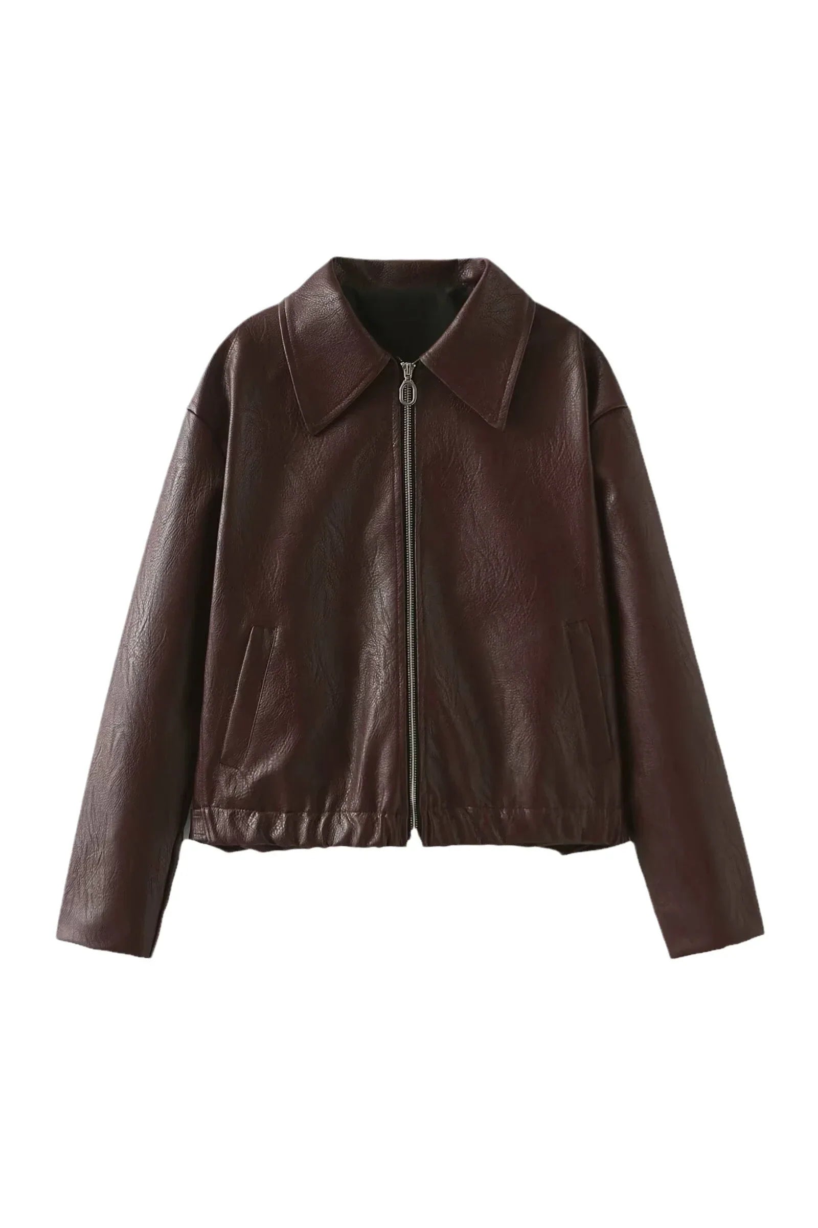 Woman in burgundy faux leather bomber jacket and black jeans.