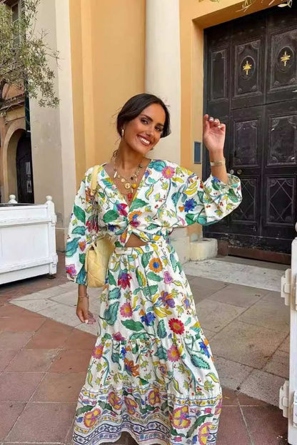 Woman wearing a floral print cotton maxi dress with a cutout waist.