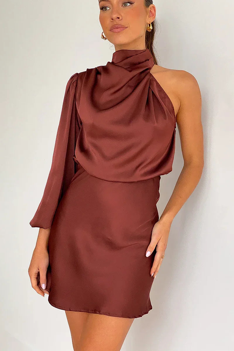 Woman in burgundy satin one shoulder mini dress