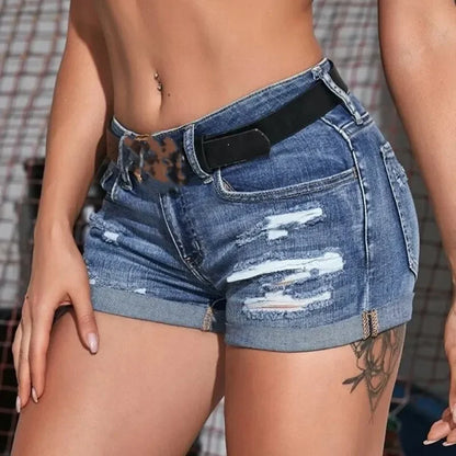 Woman wearing ripped denim shorts with black belt