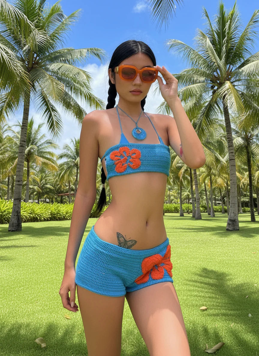 Woman in turquoise and orange crocheted bikini top and shorts set