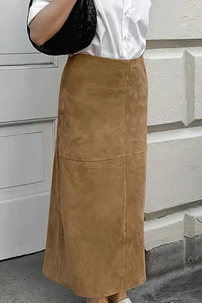 Woman wearing camel suede maxi skirt with white knit cardigan