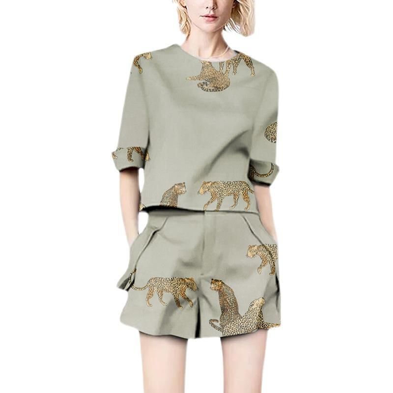 Woman wearing a sage green linen blend two-piece set with leopard print.