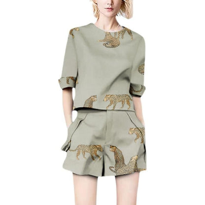 Woman wearing a sage green linen blend two-piece set with leopard print.