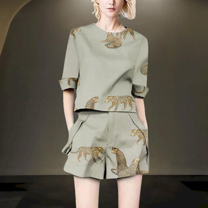 Woman wearing a sage green linen blend two-piece set with leopard print.