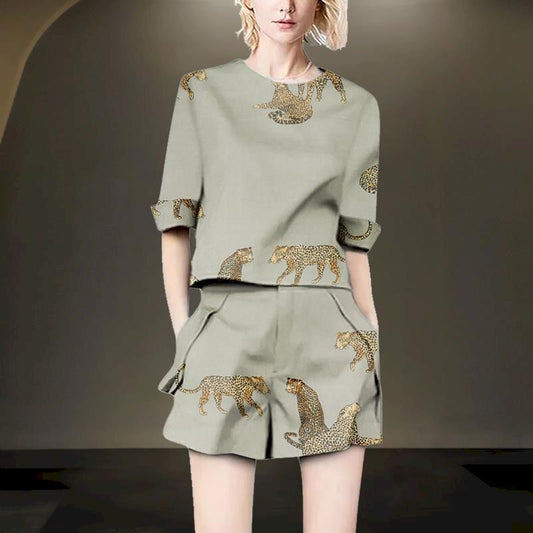 Woman wearing a sage green linen blend two-piece set with leopard print.