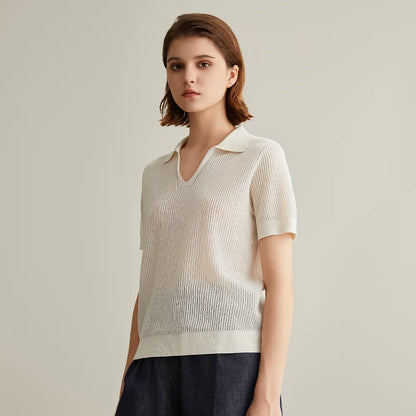 Woman wearing a light gray ribbed knit polo shirt.