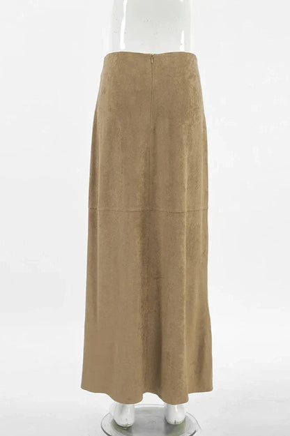 Woman wearing camel suede maxi skirt with white knit cardigan