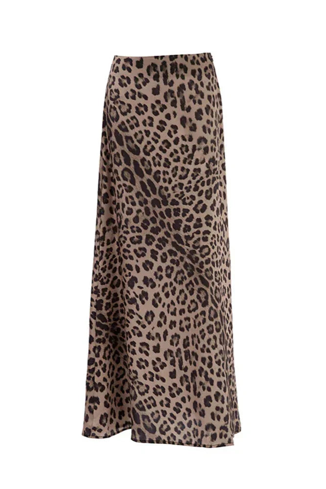 Woman wearing a black tube top and a leopard print satin maxi skirt.