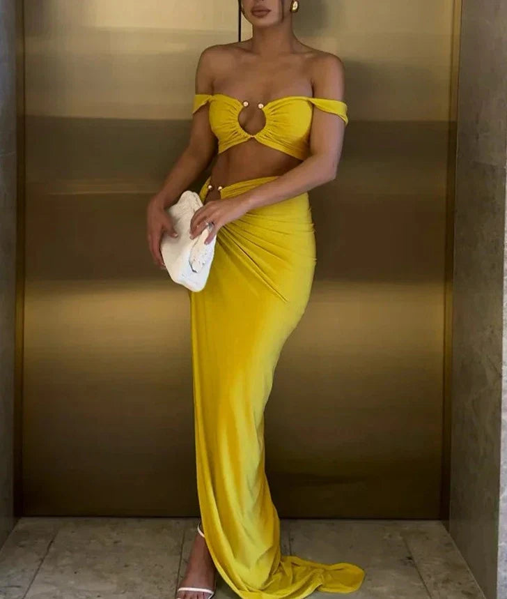 Woman wearing a blue ribbed knit two-piece set with cutout details.