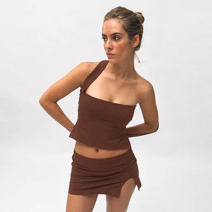 Woman in chocolate brown ribbed knit one-shoulder top and mini skirt.