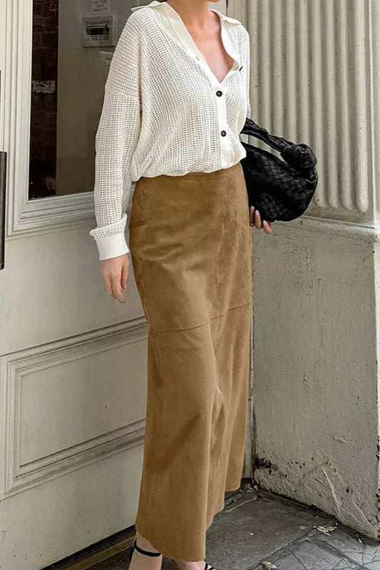 Woman wearing camel suede maxi skirt with white knit cardigan