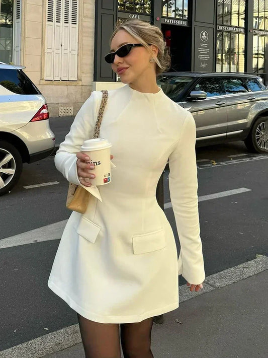 Woman in white crepe mini dress with coffee cup