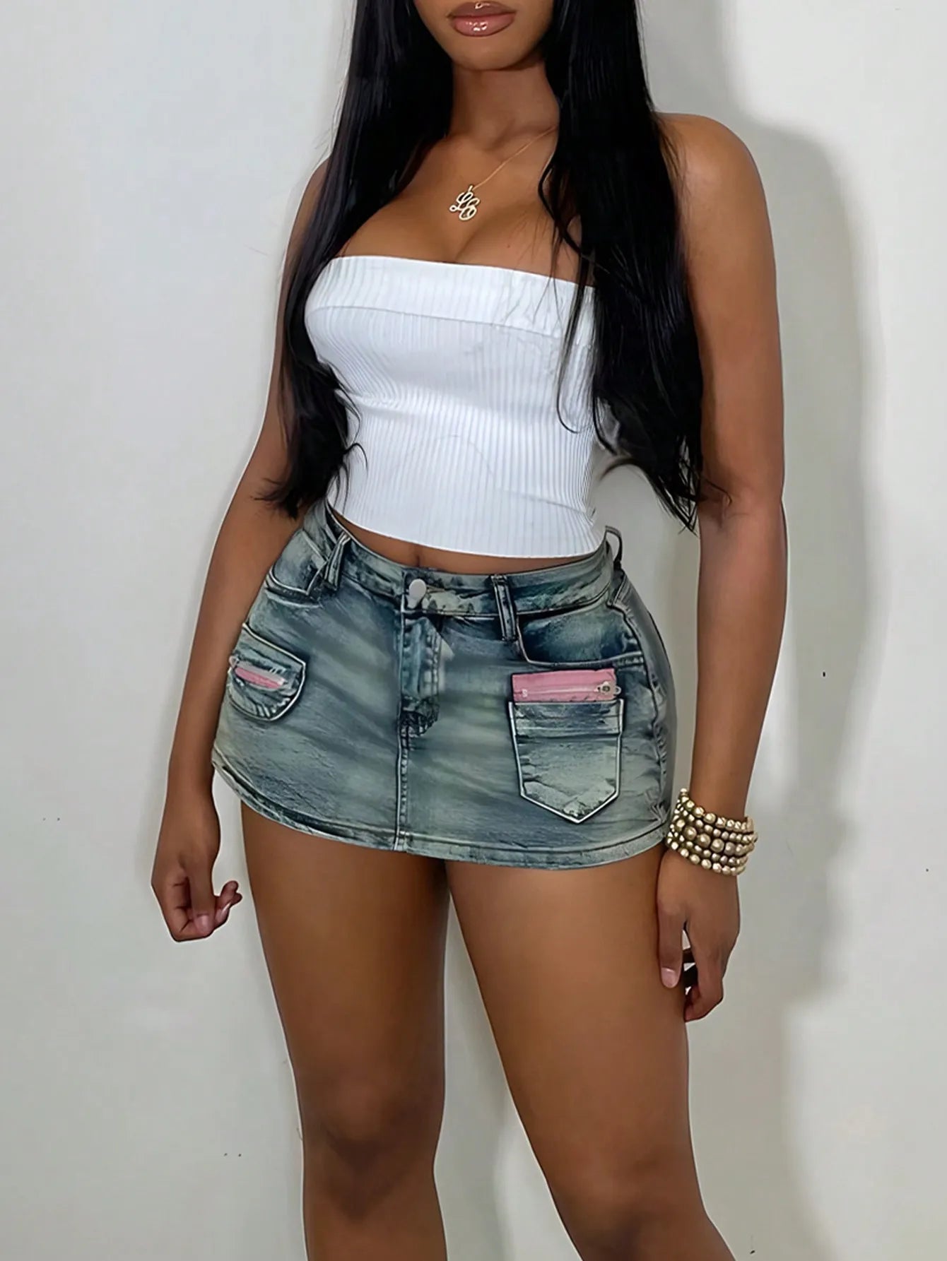Woman wearing a denim mini skirt and white tube top