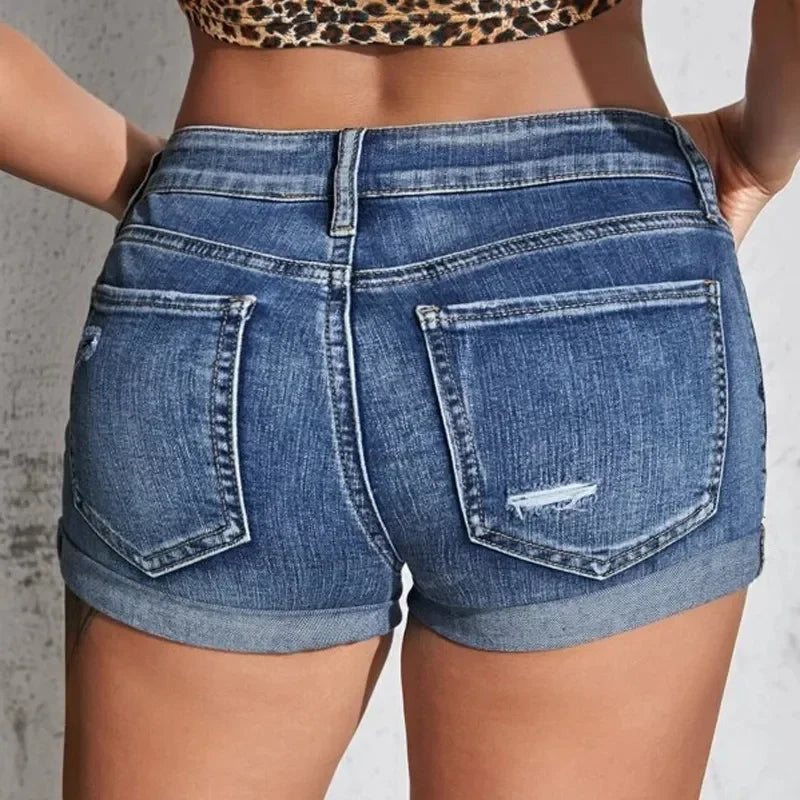 Woman wearing ripped denim shorts with black belt