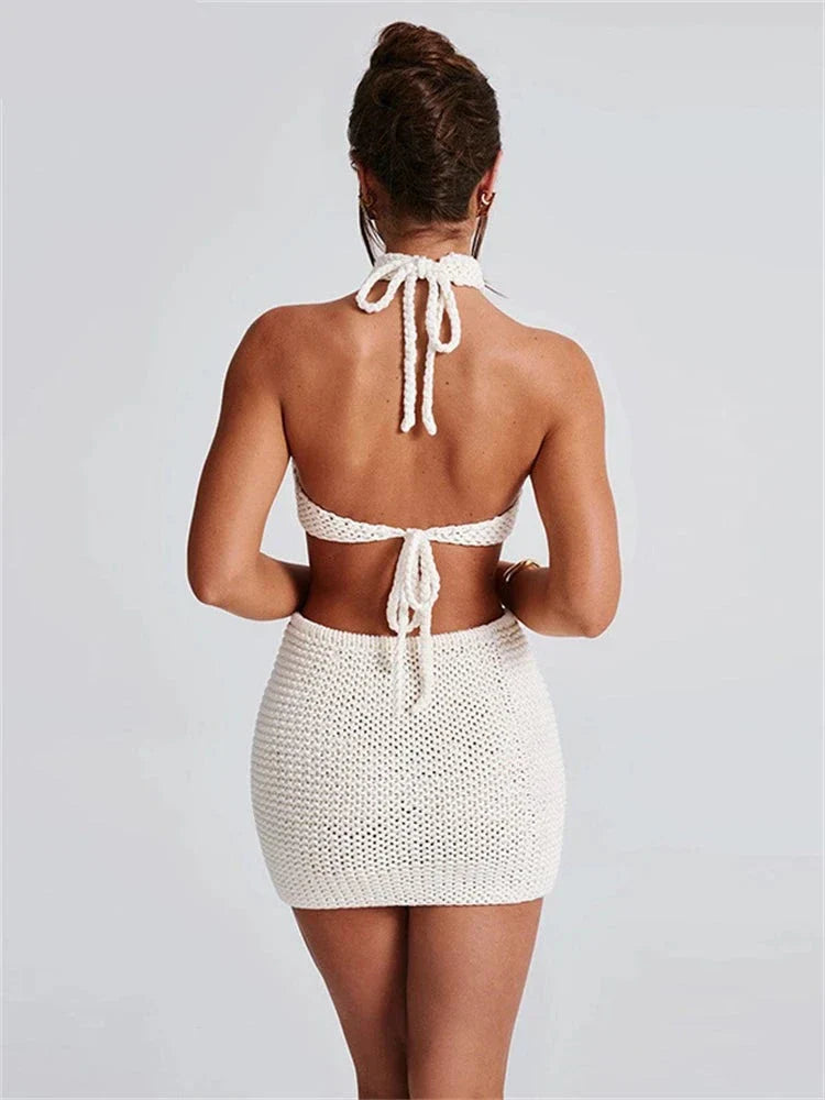 Woman wearing cream knit halter top and mini skirt set