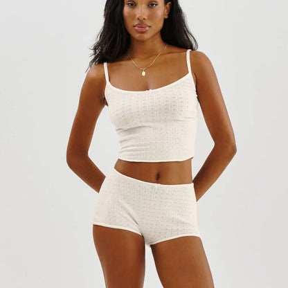 Woman in dusty rose ribbed knit pajama set with bow details