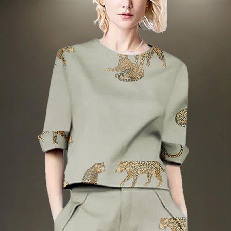 Woman wearing a sage green linen blend two-piece set with leopard print.