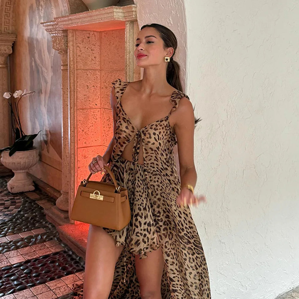Woman in leopard print chiffon maxi dress with tan handbag