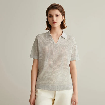 Woman wearing a light gray ribbed knit polo shirt.
