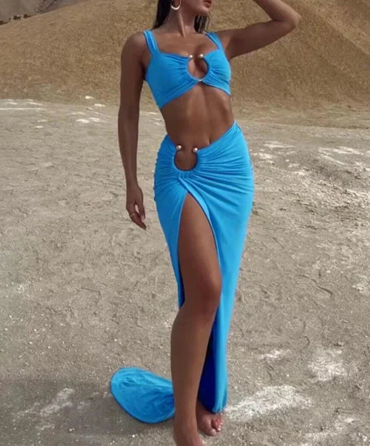 Woman wearing a blue ribbed knit two-piece set with cutout details.