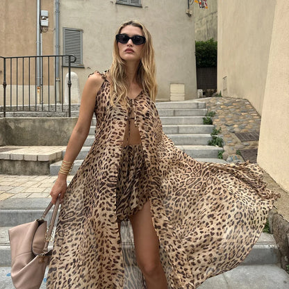 Woman in leopard print chiffon maxi dress with tan handbag