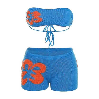 Woman in turquoise and orange crocheted bikini top and shorts set