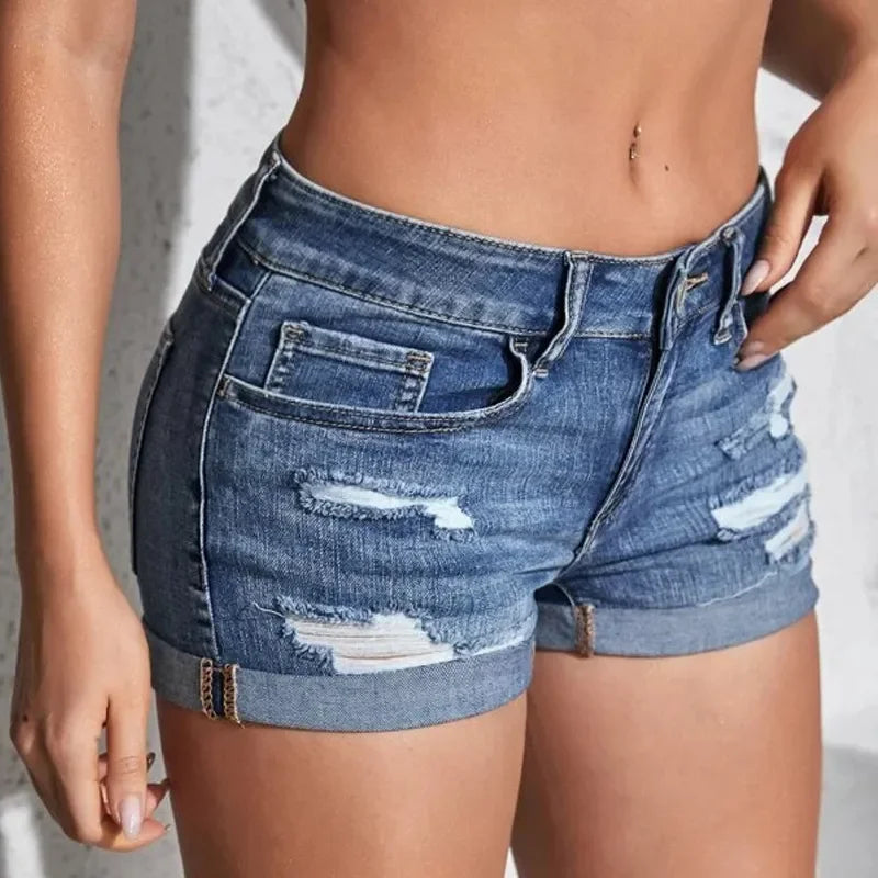 Woman wearing ripped denim shorts with black belt