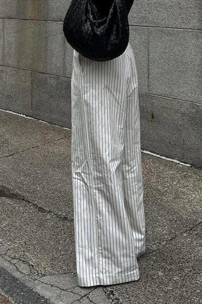 Woman wearing white and gray striped linen wide-leg pants