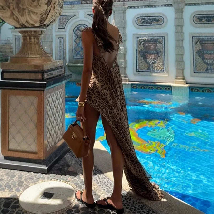 Woman in leopard print chiffon maxi dress with tan handbag