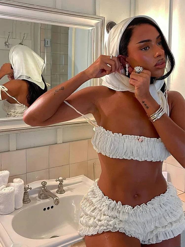 Woman in white shirred cotton crop top and shorts set