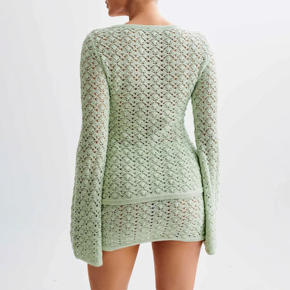 Woman wearing a white crochet knit cardigan and skirt set.