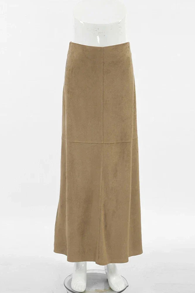 Woman wearing camel suede maxi skirt with white knit cardigan