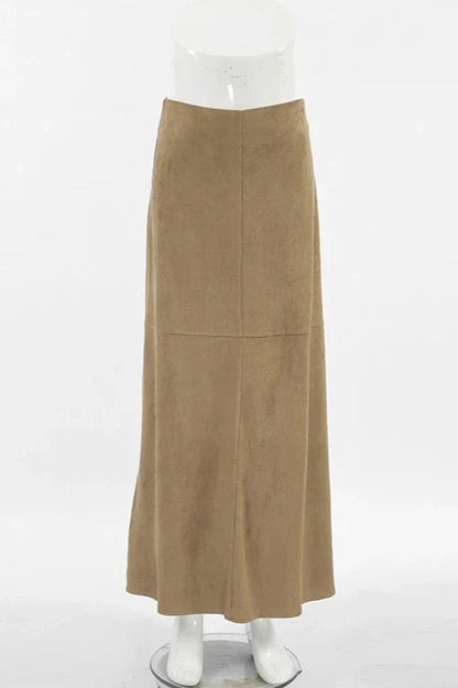 Woman wearing camel suede maxi skirt with white knit cardigan