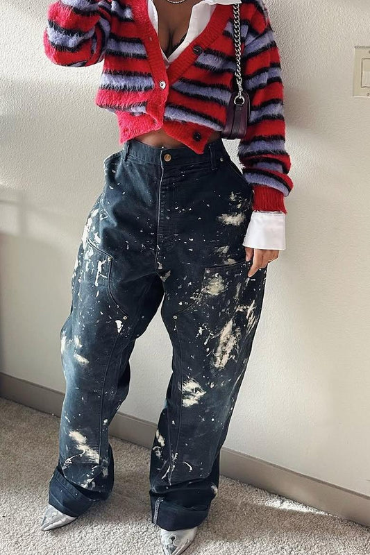 Woman wearing red and lavender striped fuzzy cardigan with paint-splattered jeans.