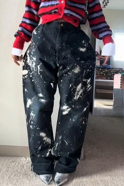 Woman wearing red and lavender striped fuzzy cardigan with paint-splattered jeans.