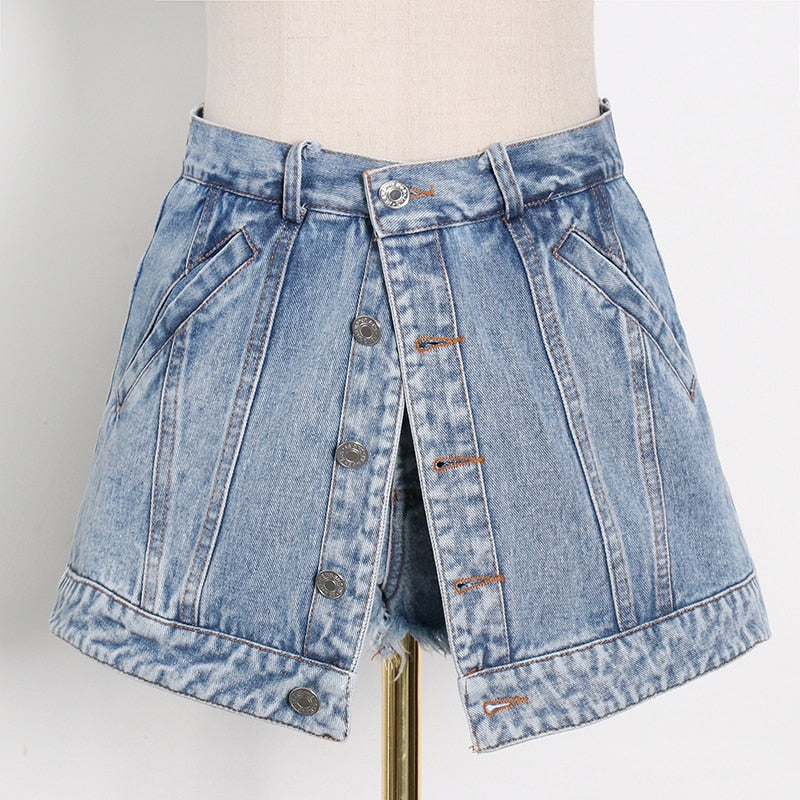 Woman wearing light wash denim skort with button detail