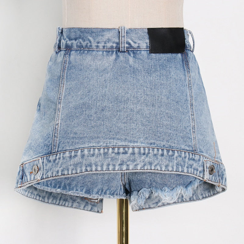 Woman wearing light wash denim skort with button detail