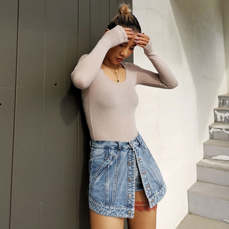 Woman wearing light wash denim skort with button detail