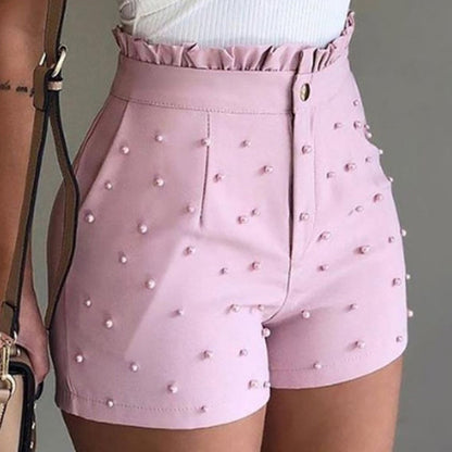 Pink faux leather shorts with pearl embellishments