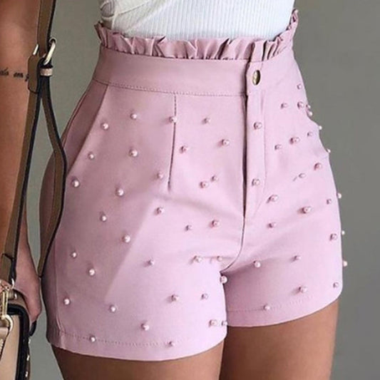Pink faux leather shorts with pearl embellishments