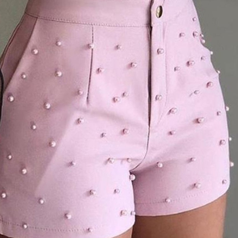 Pink faux leather shorts with pearl embellishments