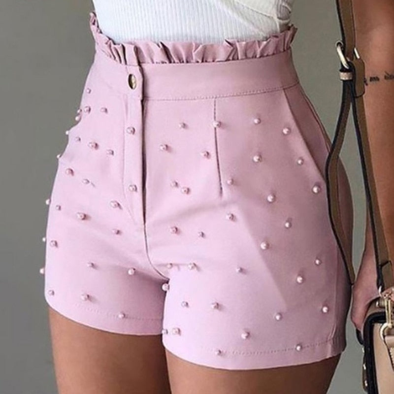 Pink faux leather shorts with pearl embellishments