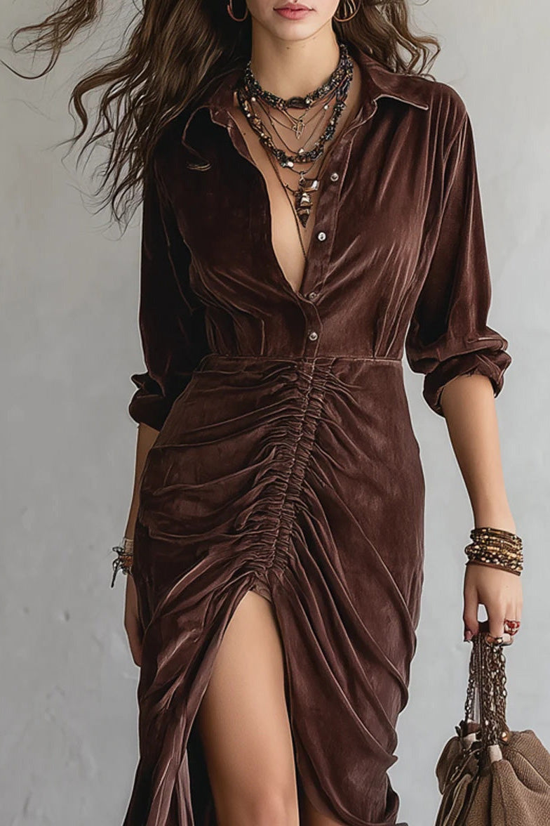 Woman in brown velvet midi dress with cowboy boots and a brown bag