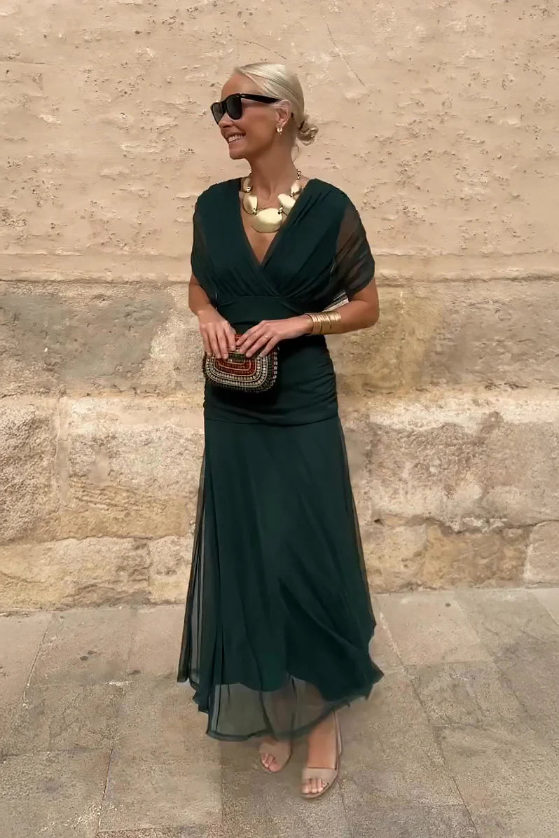 Woman in floral chiffon off-the-shoulder maxi dress