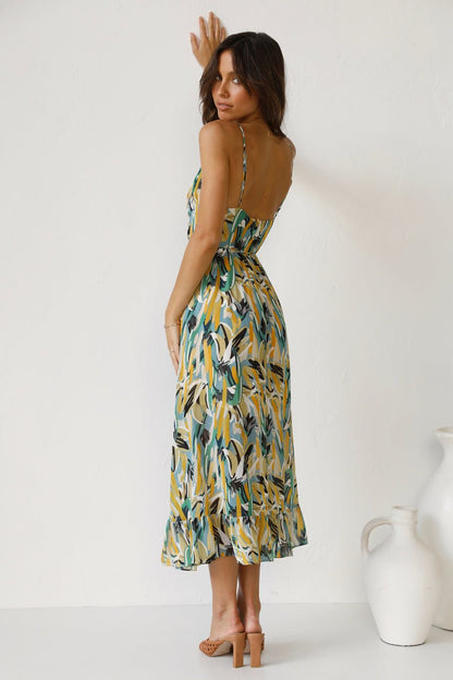 Woman in flowing multi-colored chiffon midi dress