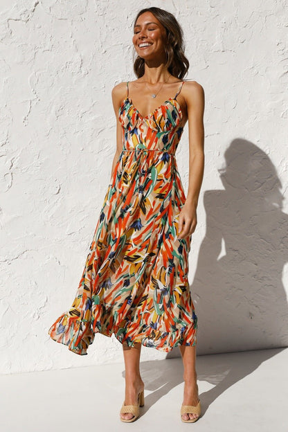 Woman in flowing multi-colored chiffon midi dress