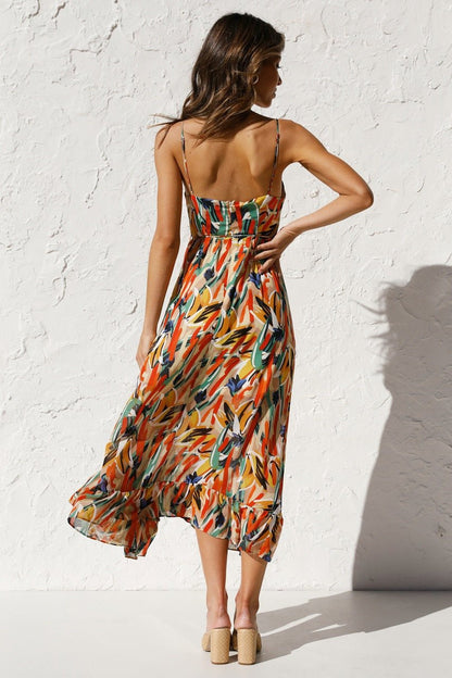 Woman in flowing multi-colored chiffon midi dress